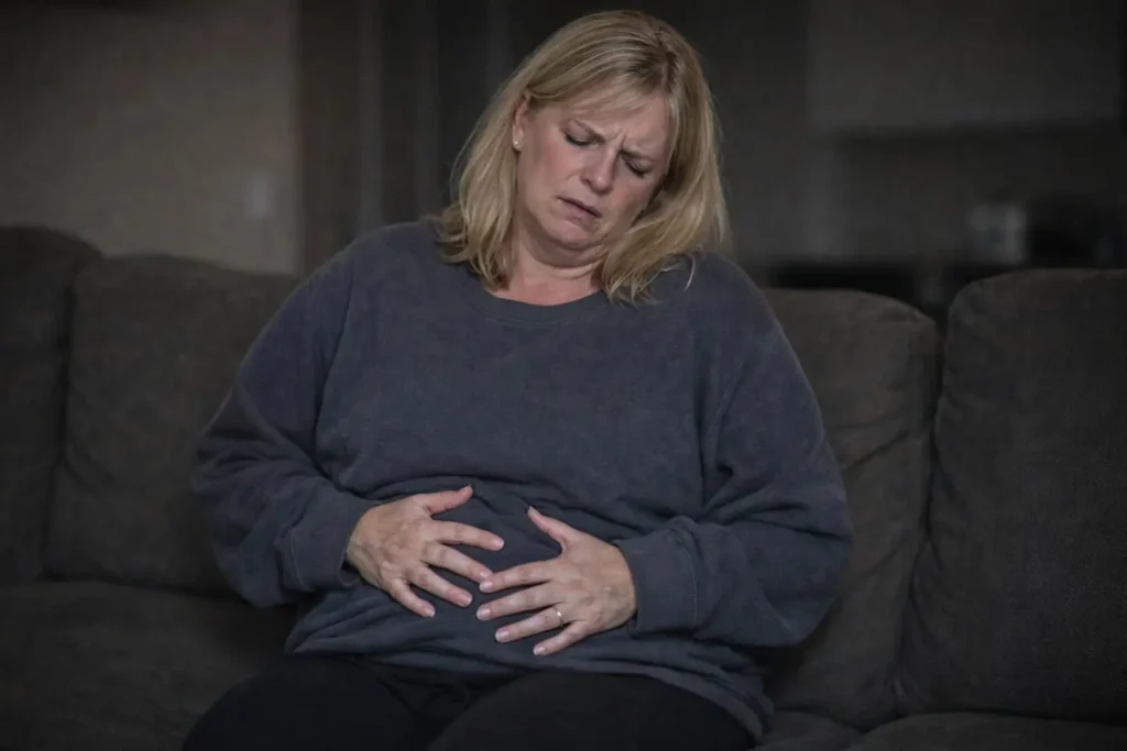 Woman suffering from painful bloating and weight gain before starting Lulutox Tea